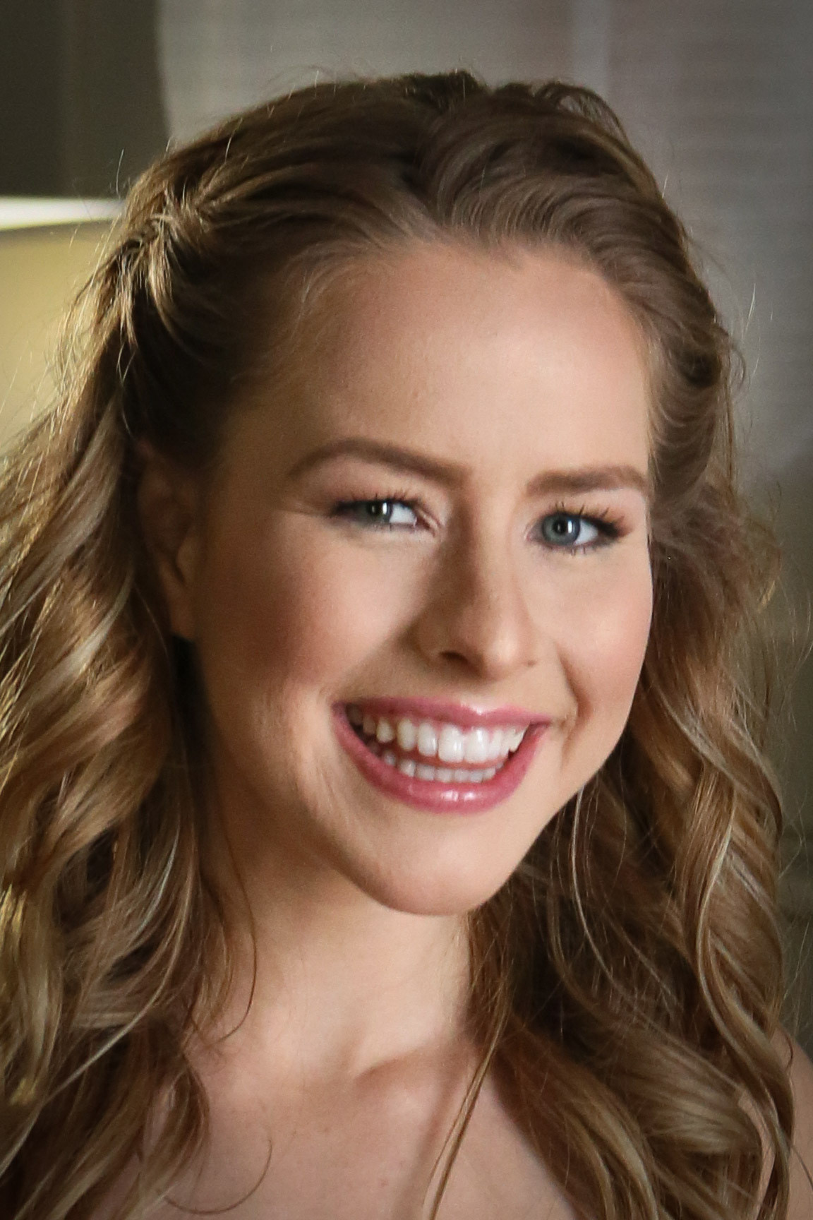 Lilly Ford smiling portrait, wavy blonde hair